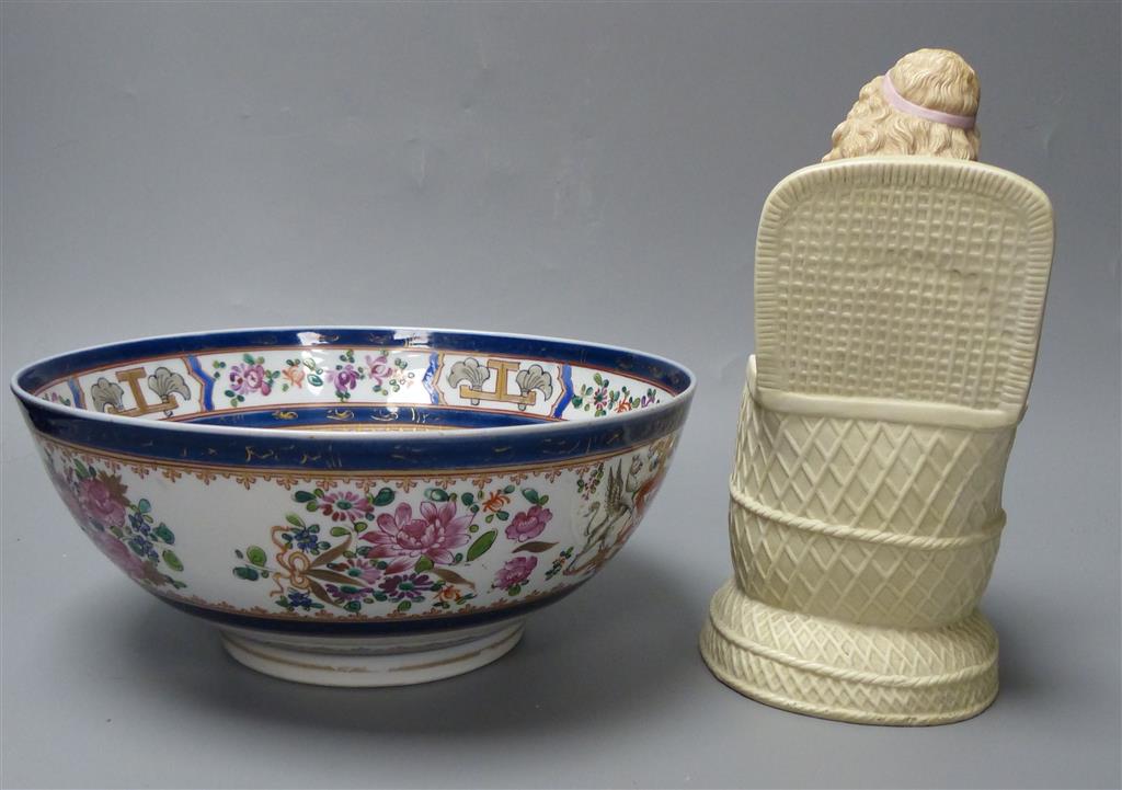 A French coloured biscuit porcelain figure of a seated girl and a Samson armorial bowl, c.1900, diameter 23cm